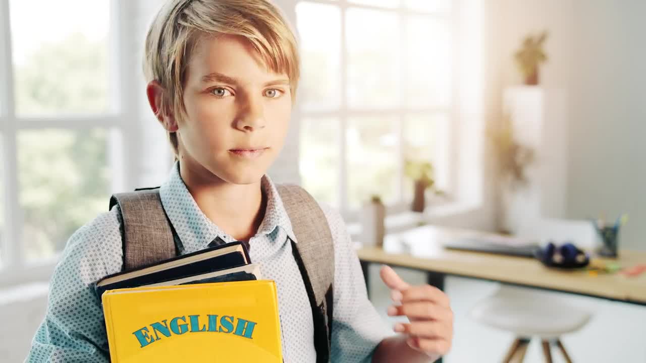 Free Video Stock Smiling Boy Holds English Education Book In Bright Room Live Wallpaper - Free Download