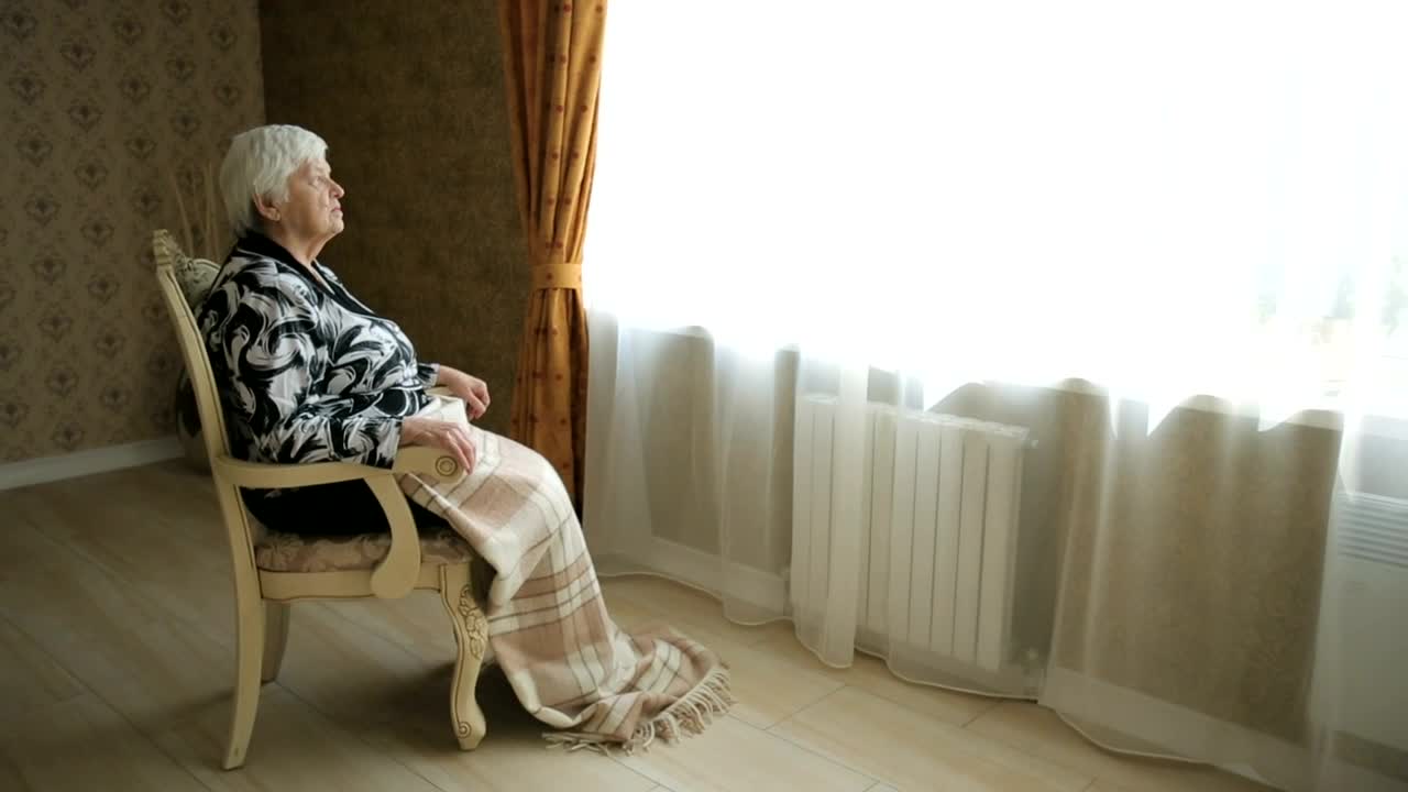 Stock Video Elderly Woman Sitting In Front Of The Window Live Wallpaper For PC - Free Download