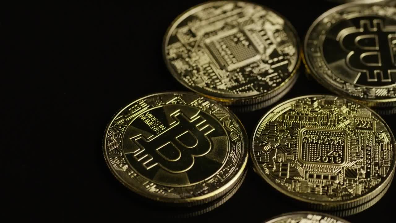 Stock Video Golden Bitcoin Coins Rotating On A Black Surface Live Wallpaper For PC - Free Download