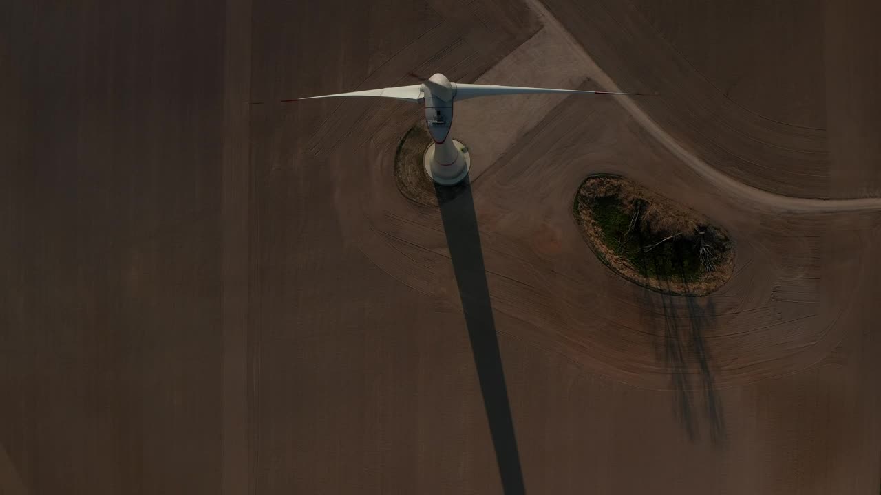 Free Video Stock top aerial shot of a wind turbine spinning Live Wallpaper - Free Download