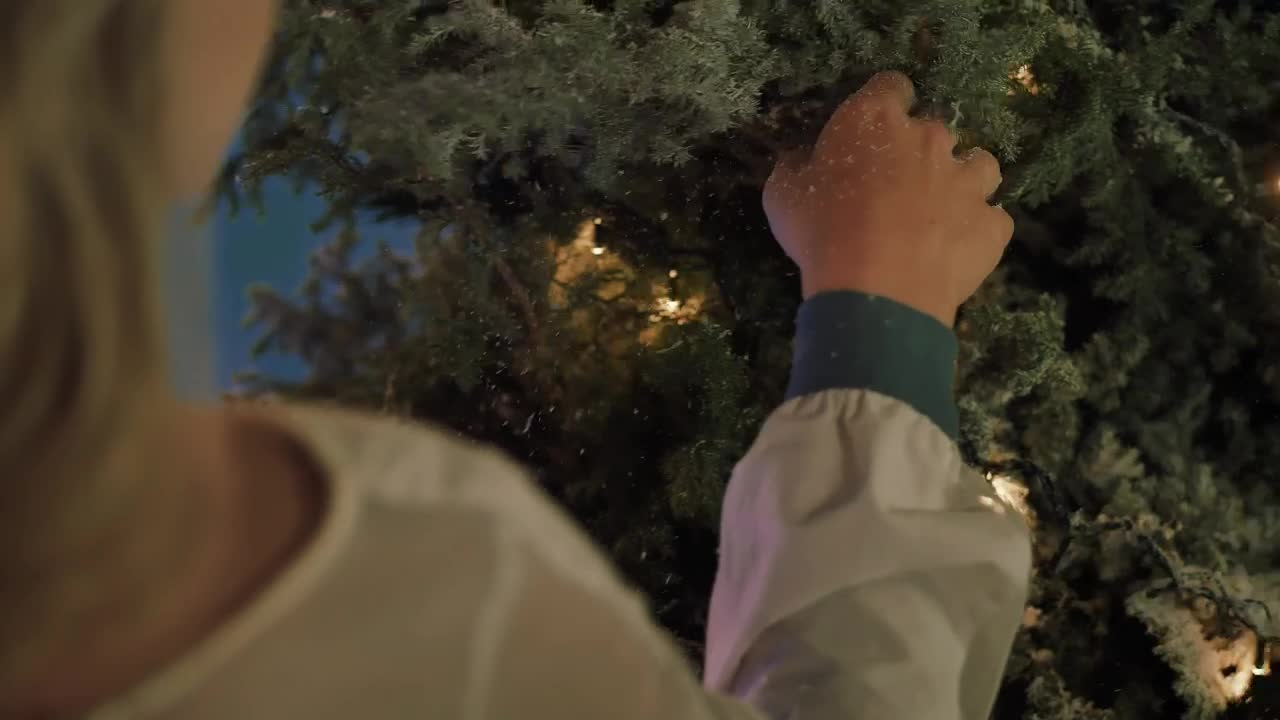 Stock Video Hand Of A Girl Touching A Snowy Christmas Tree Live Wallpaper For PC - Free Download