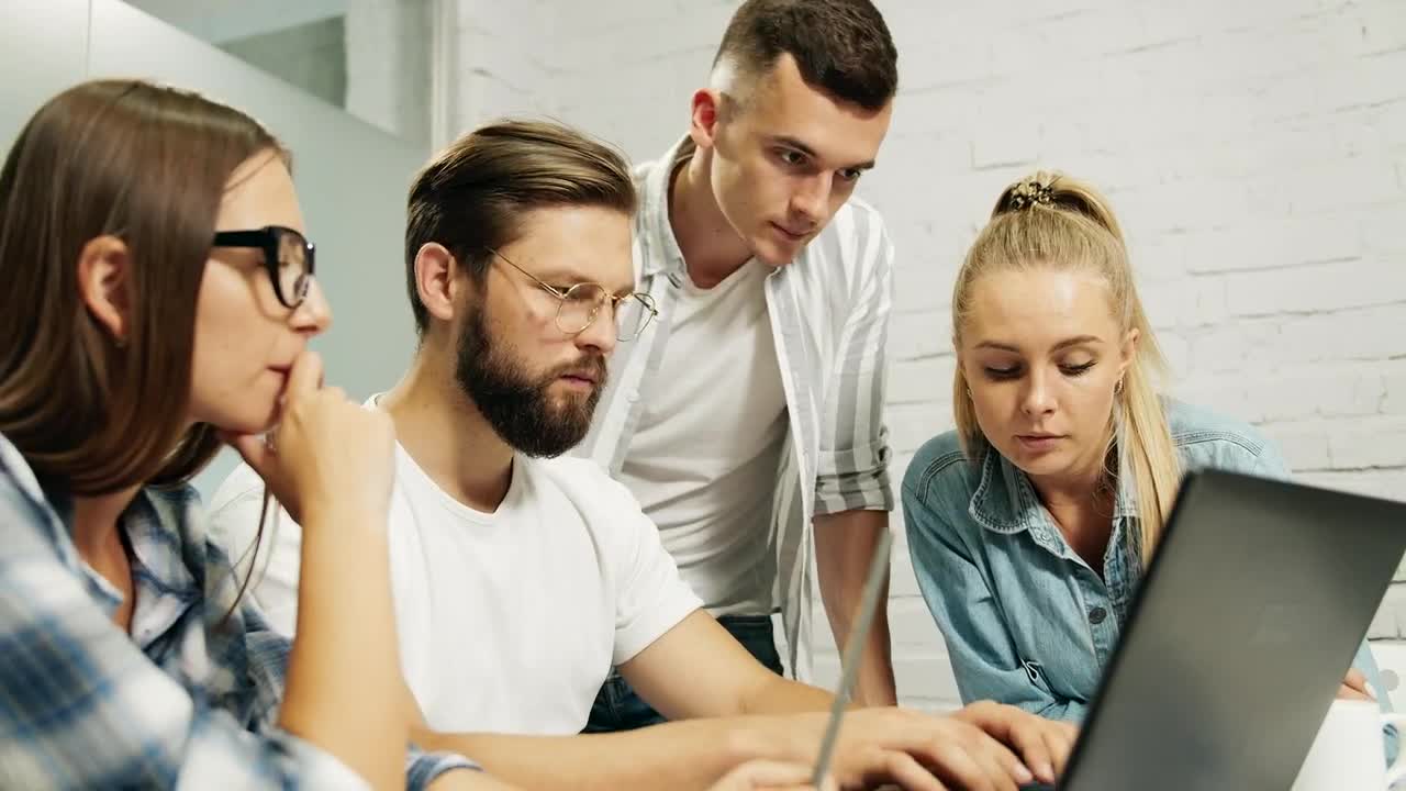Stock Video Leader Types On Laptop While Team Look Over Shoulder Animated Wallpaper - Free Download