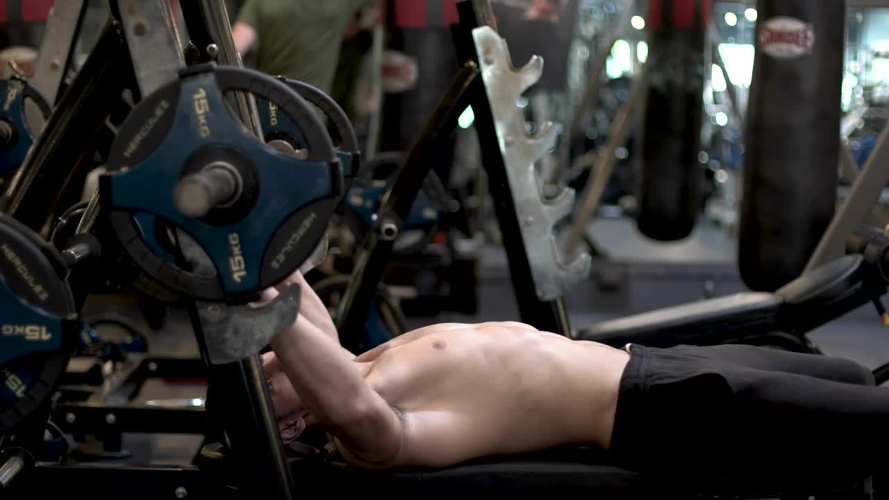 Stock Video Man At The Gym Exercising With A Dumbbell Animated Wallpaper - Free Download