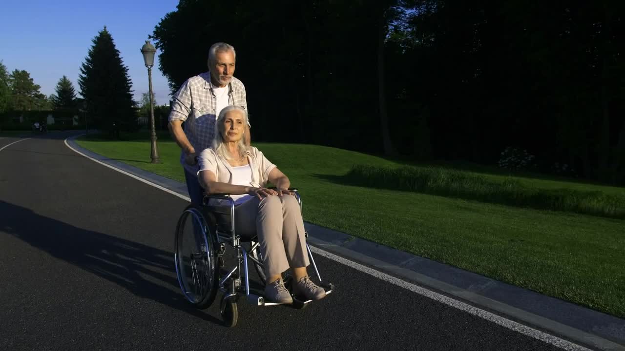 Stock Video Man Pushing His Wife In Her Wheelchai Animated Wallpaper - Free Download