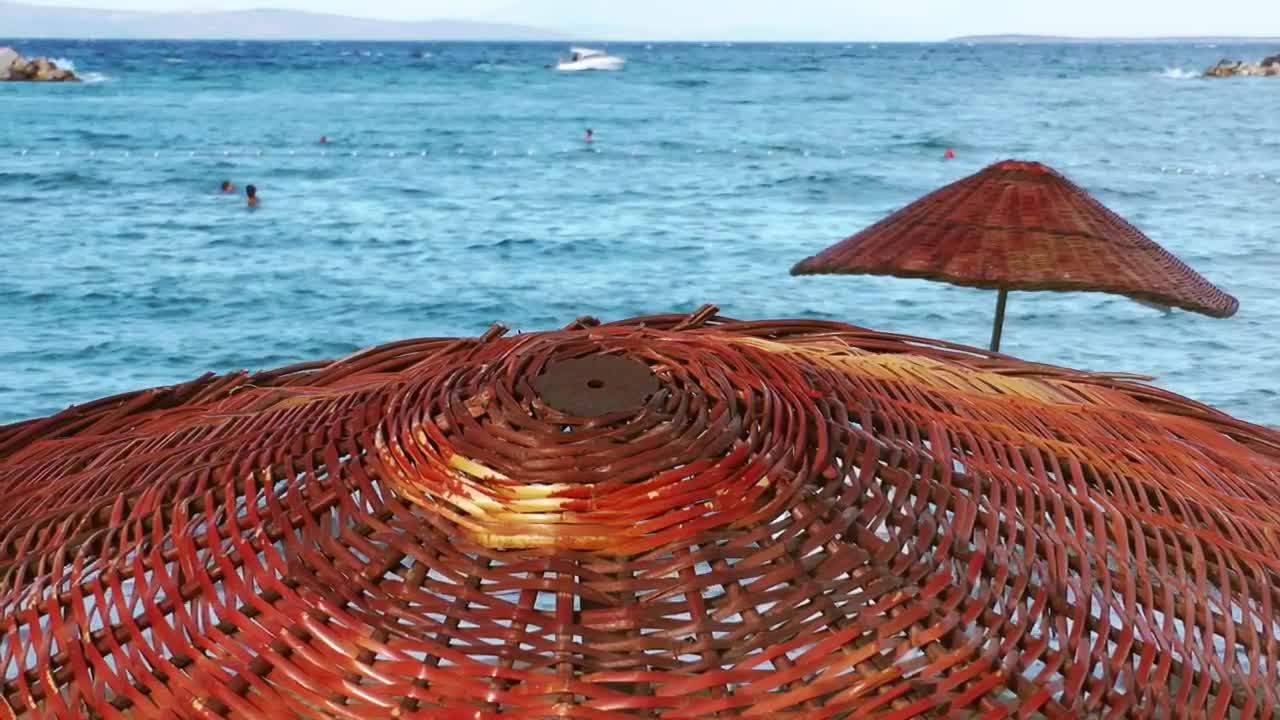 Free Video Stock the sea seen from above a wooden umbrella Live Wallpaper - Free Download