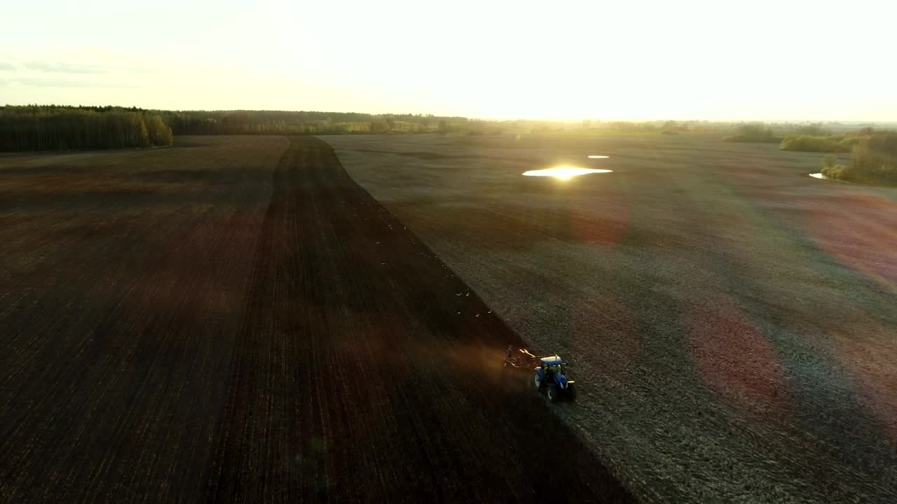 Free Video Stock tractor working in the field with sunbeams Live Wallpaper - Free Download