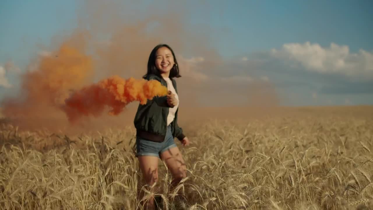 Stock Video Happy Girl Jumping With A Smoke Flare Animated Wallpaper - Free Download