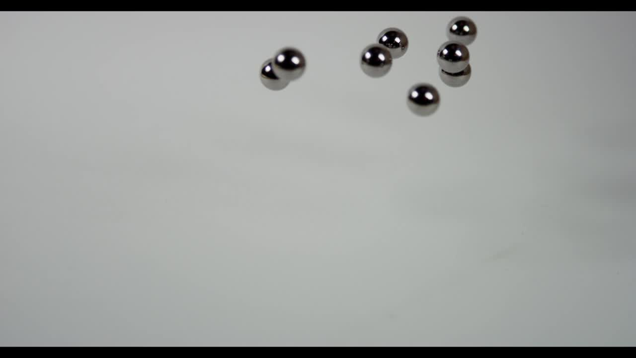 Stock Video Metal Pellets Fall On White Surfac Animated Wallpaper - Free Download