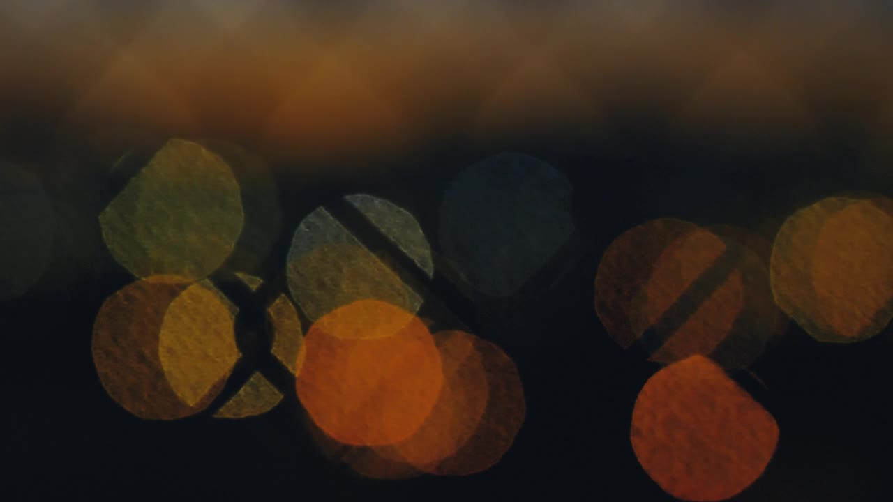 Stock Video Lights Out Of Focus Through A Wire Fence Animated Wallpaper - Free Download