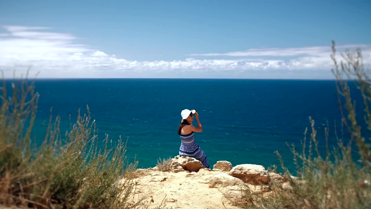 Free Stock Video Woman Sitting On The Edge Of A Cape Overlooking The Live Wallpaper - Free Download