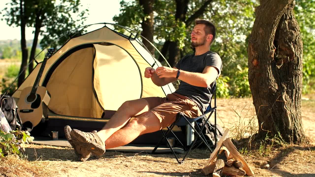 Stock Video Man Relaxing In His Camp In Natur Animated Wallpaper - Free Download