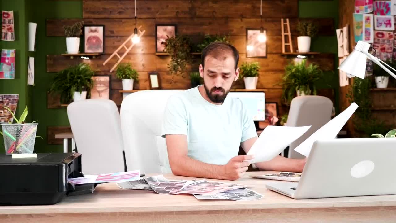 Stock Video Creative Man Prints Out Ideas In Home Office Live Wallpaper For PC - Free Download