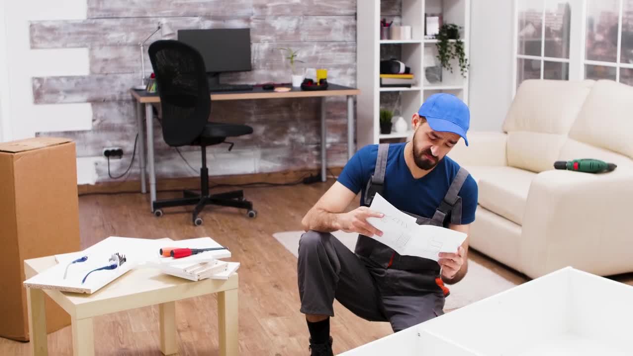 Stock Video Man Is Confused By Instructions For Furniture Assembl Animated Wallpaper - Free Download
