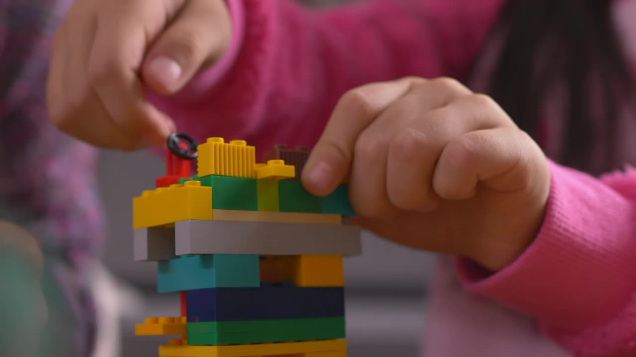 Stock Video Girl Putting Together A Figure With Legos Live Wallpaper For PC - Free Download