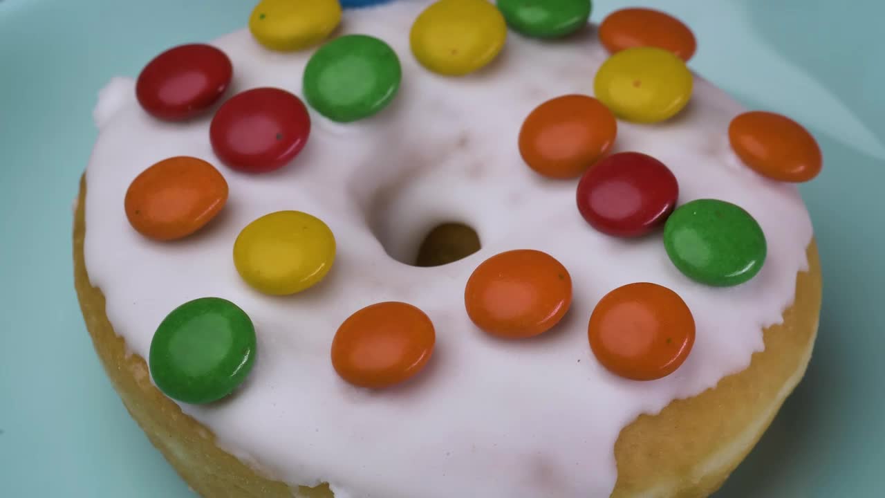 Free Video Stock taking glazed donut with colored chocolates from a plate Live Wallpaper - Free Download