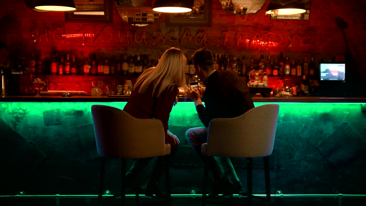 Stock Video Couple Checking Something In A Smartphone In A Bar Live Wallpaper For PC - Free Download