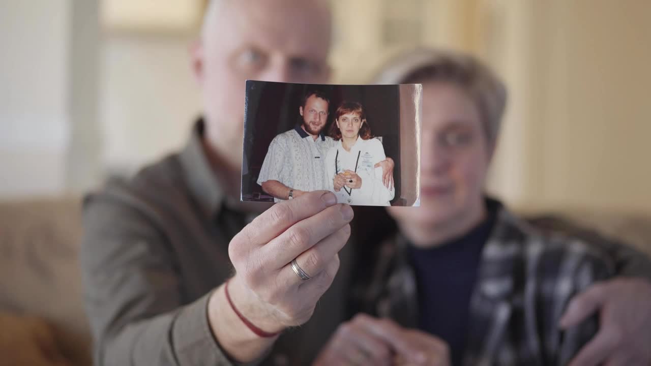 Stock Video Couple Showing An Old Photograph Of Them Live Wallpaper For PC - Free Download