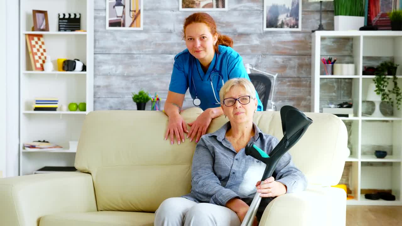 Stock Video Nurse Stands With Elderly Patient Sitting On Sofa Live Wallpaper - Free Download