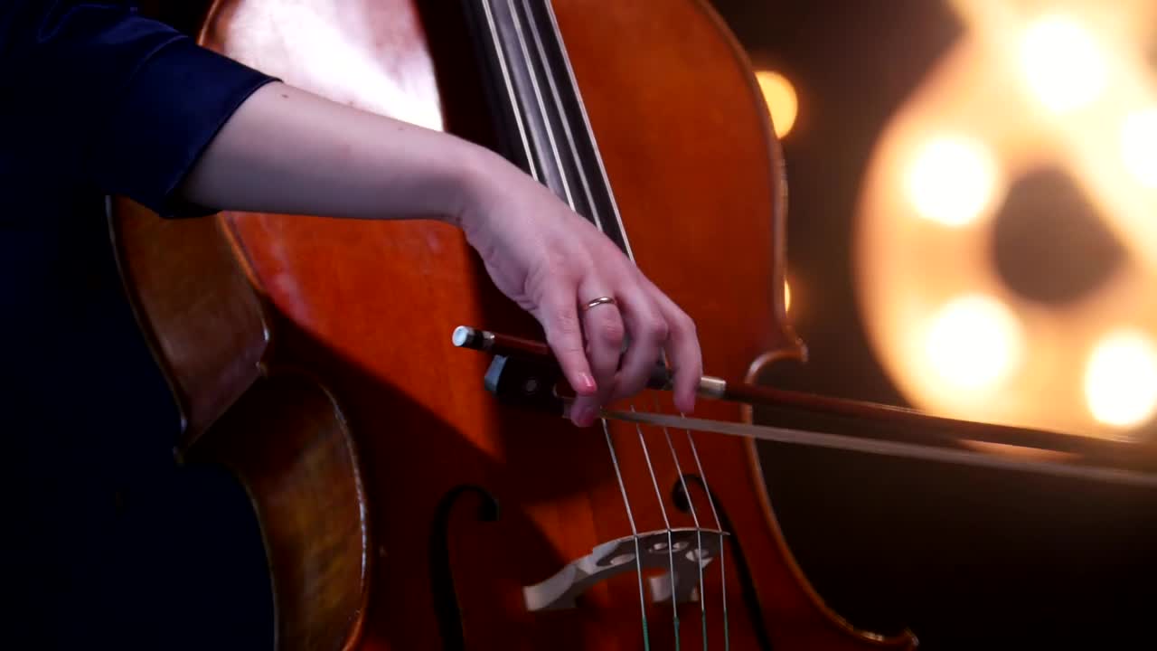 Video Stock Playing The Cello With Blurry Lights In The Background Live Wallpaper Free - Free Download