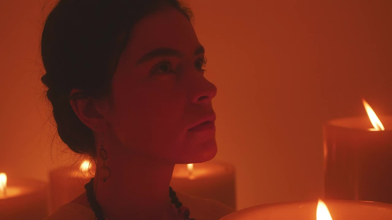 Stock Video Face Of A Spiritual Woman Meditating Among Many Candles Live Wallpaper For PC - Free Download