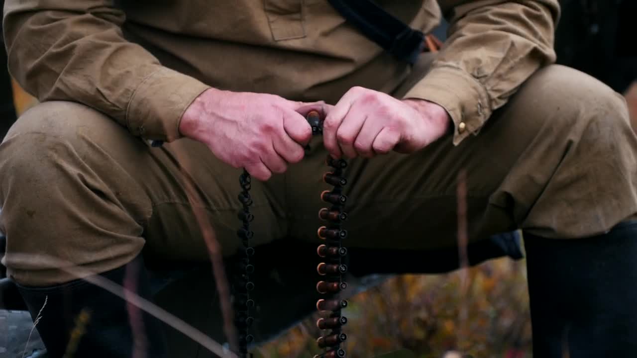 Stock Video Hunter Loading A Belt Of Bullets In A Nearby Shot Animated Wallpaper - Free Download
