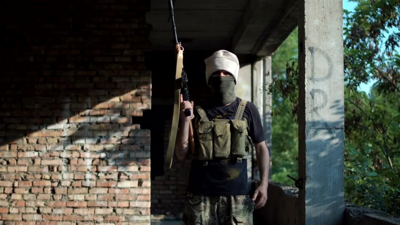Stock Video Man Posing With A Gun On An Abandoned Sit Animated Wallpaper - Free Download