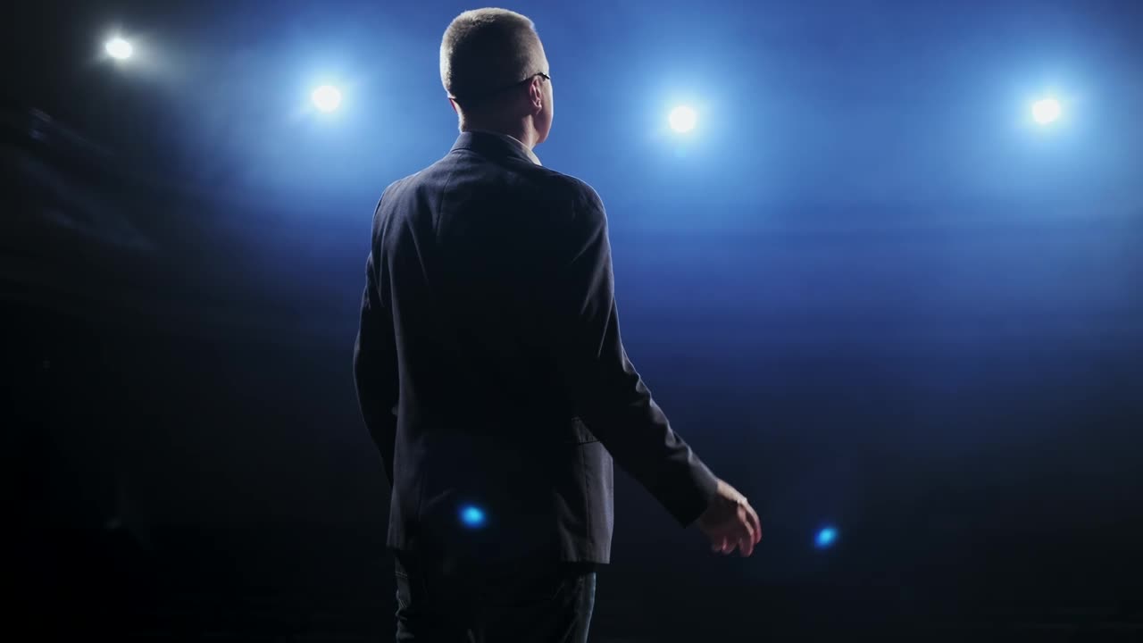 Free Video Stock Speaker In Suit Speaks To His Audience On Stage Live Wallpaper - Free Download