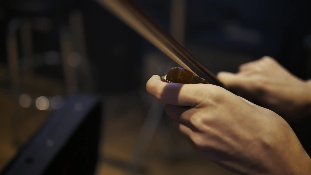 Stock Video Hands Of A Violinist Putting Pitch To Her Violin Bow Animated Wallpaper - Free Download