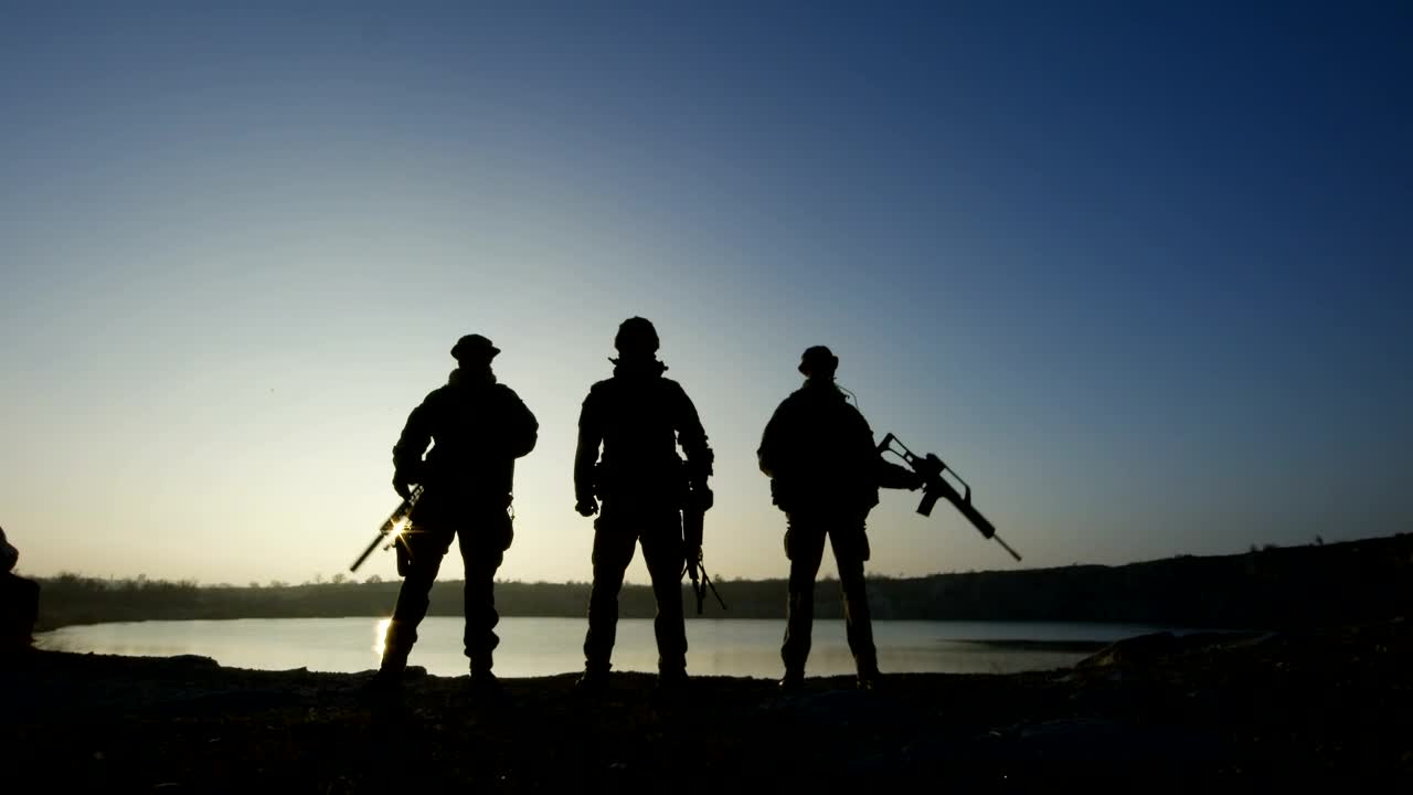 Free Video Stock three soldier silhouettes posign with guns Live Wallpaper - Free Download