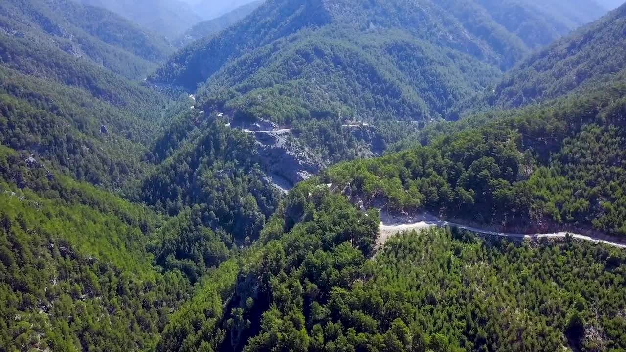 Stock Footage Winding Road Through A Mountain Forest Live Wallpaper - Free Download