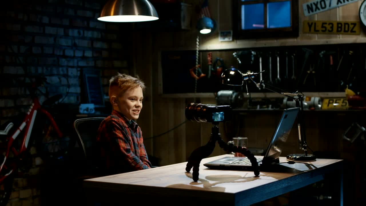 Free Video Stock teen boy doing a video blog in the garage Live Wallpaper - Free Download