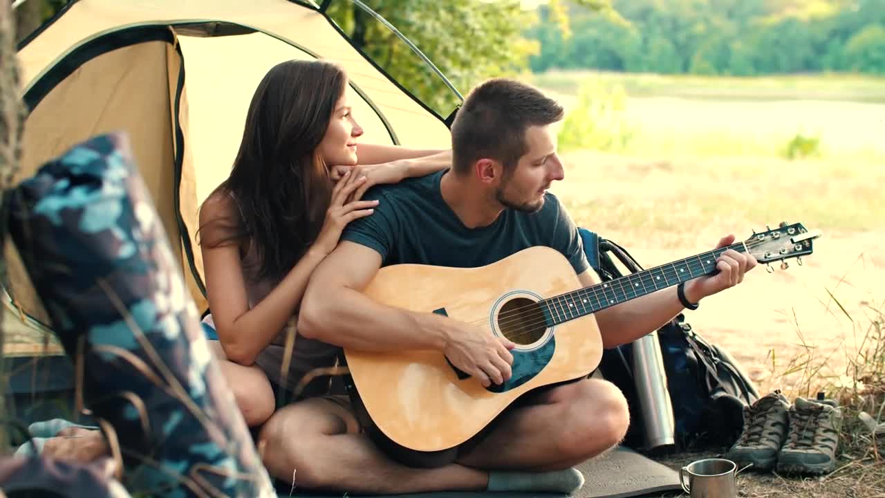 Stock Video Man Playing Guitar To His Girlfriend In Cam Animated Wallpaper - Free Download