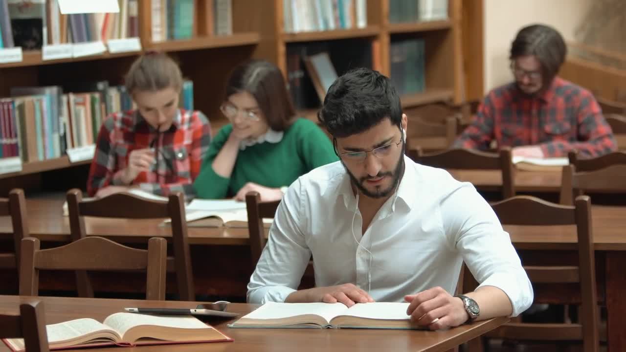 Stock Video Man Focused On Study For Exam In Library Animated Wallpaper - Free Download