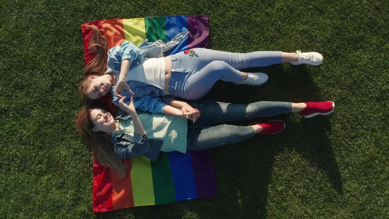 Stock Video Couple Laying On A Rainbow Flag Live Wallpaper For PC - Free Download