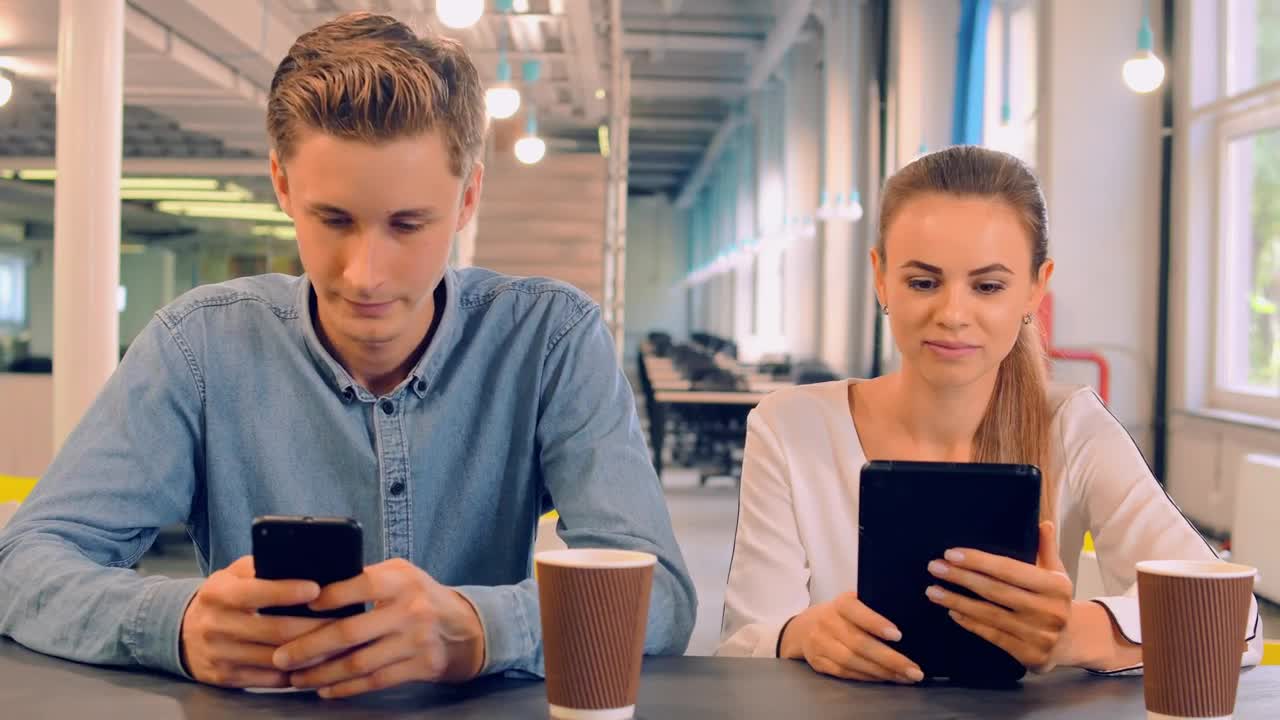 Stock Video Couple In A Cafe Connected On Their Mobile Devices Live Wallpaper For PC - Free Download