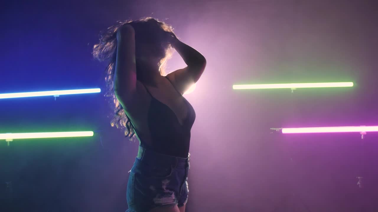 Stock Video Girl Dancing On A Dark Floor Under Colored Lights Live Wallpaper For PC - Free Download