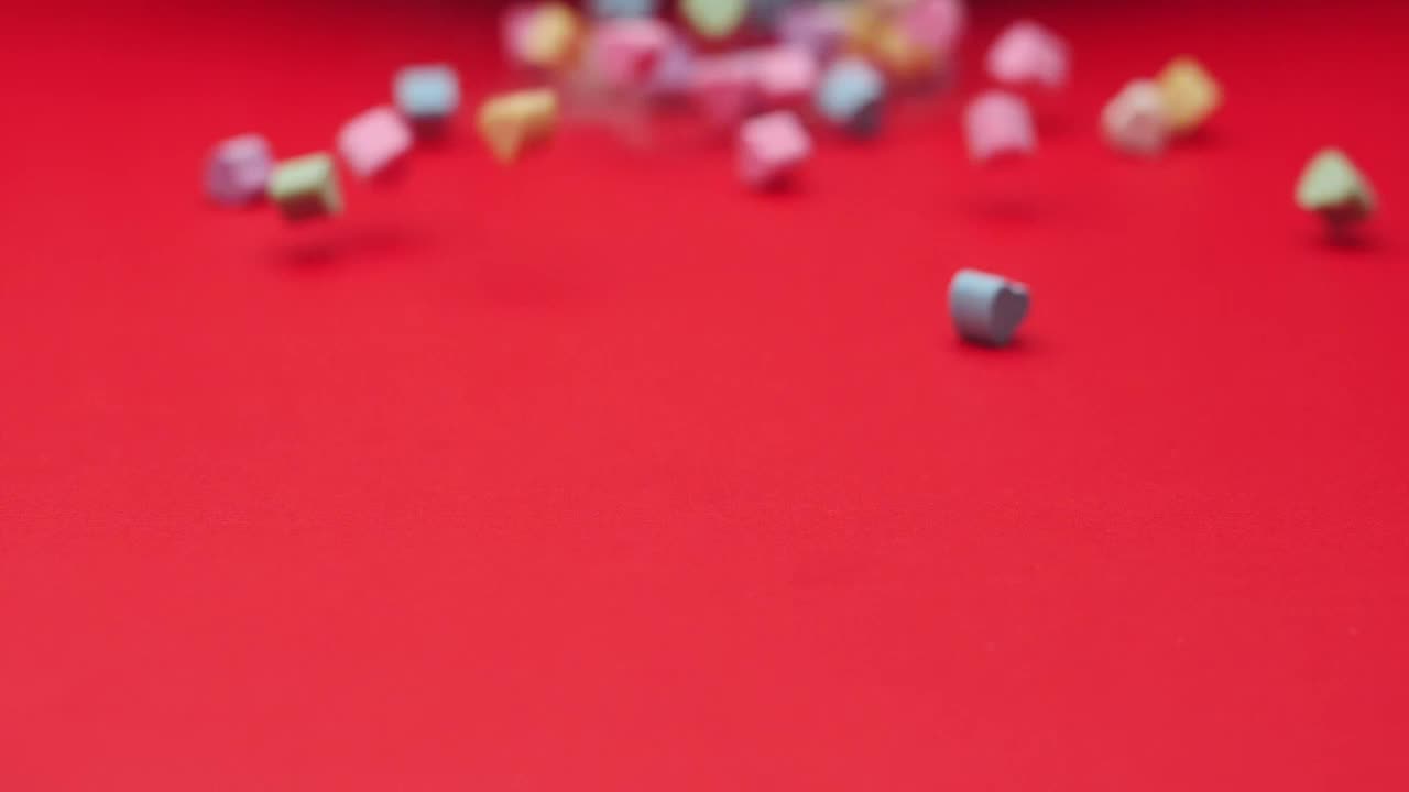 Stock Video Heart Candies Sliding On A Red Surface Animated Wallpaper - Free Download