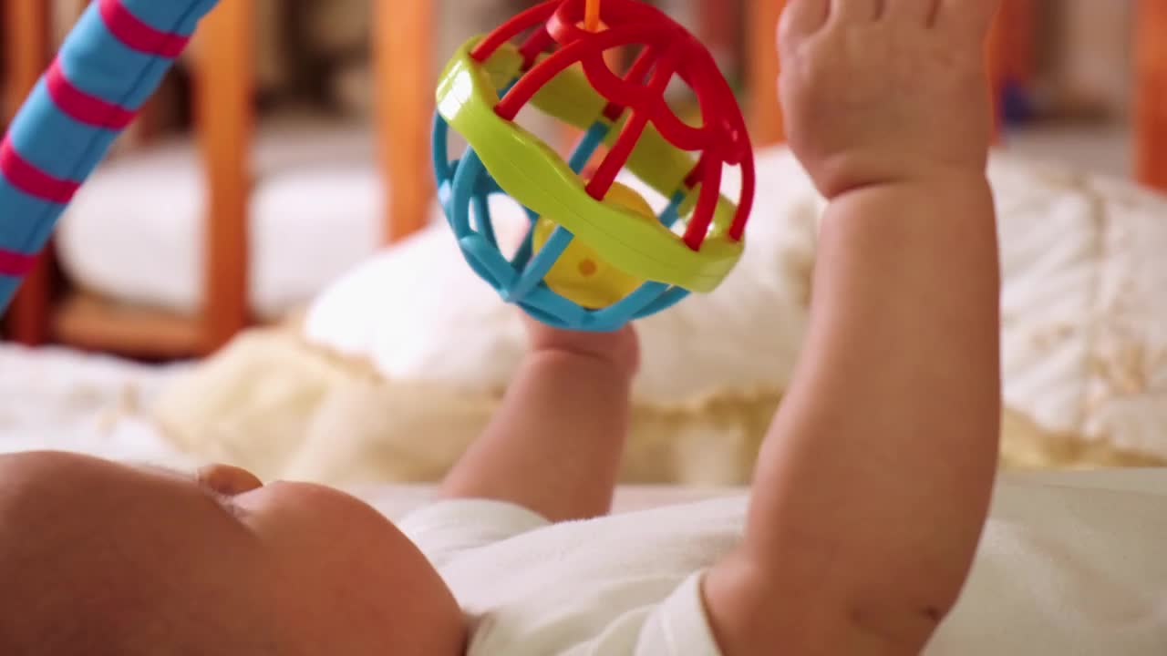 Stock Video Little Baby Playing With Toys On His Bed Animated Wallpaper - Free Download