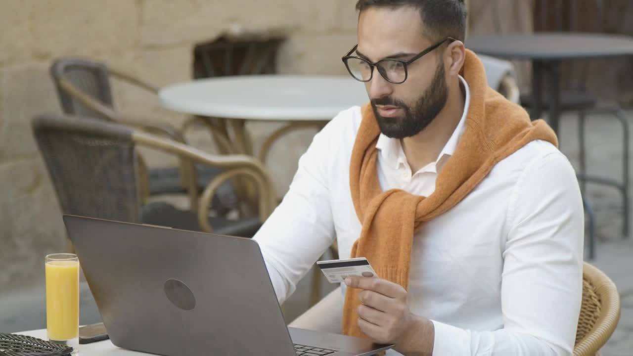Stock Video Man Shops Online In Cafe And Pays With Credit Car Animated Wallpaper - Free Download