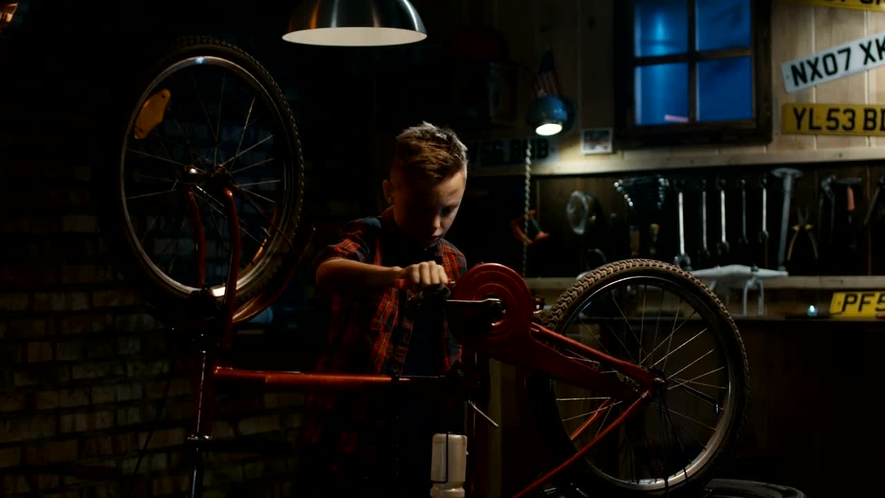 Free Video Stock teen boy repairing his bicycle in the garage Live Wallpaper - Free Download