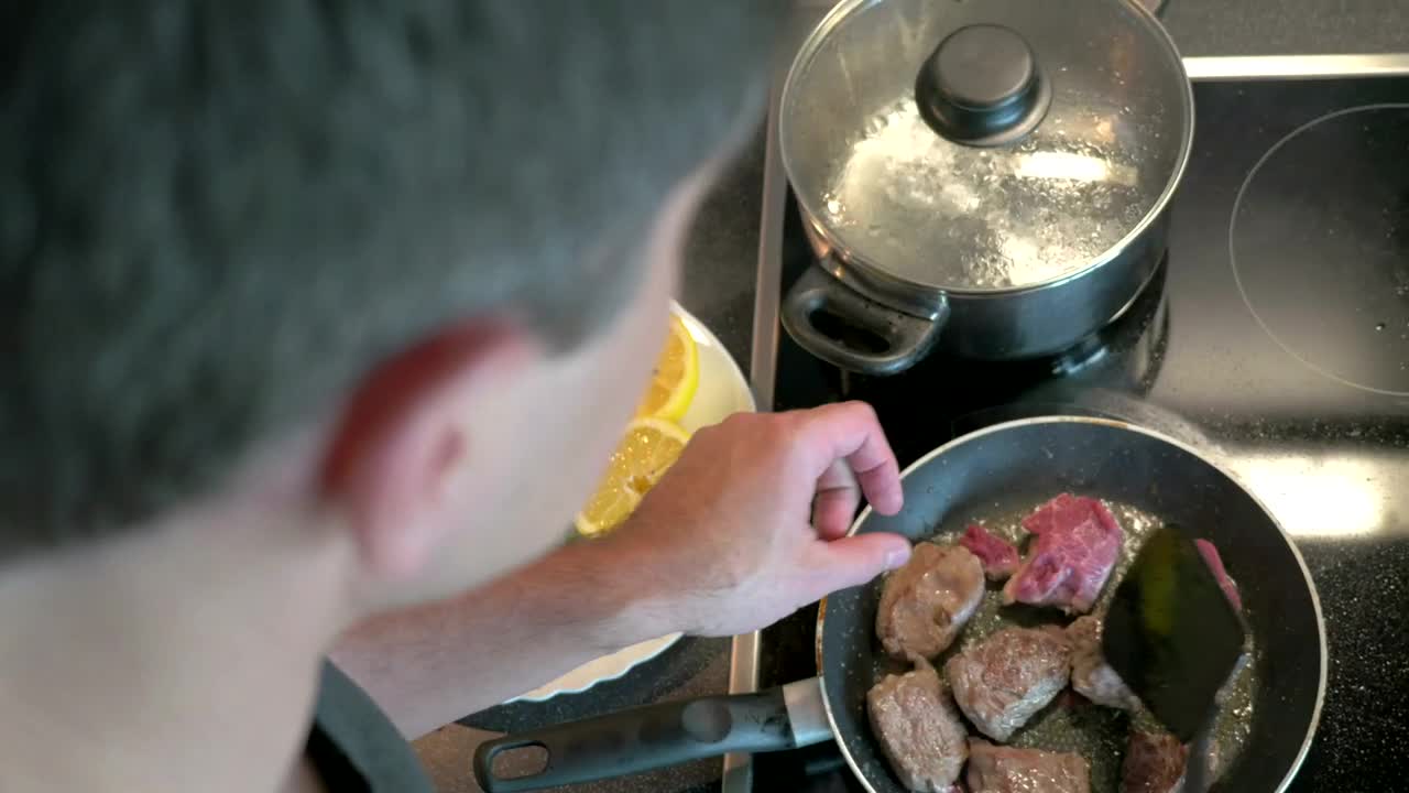 Stock Video Man Preparing Beef In A Frying Pa Animated Wallpaper - Free Download