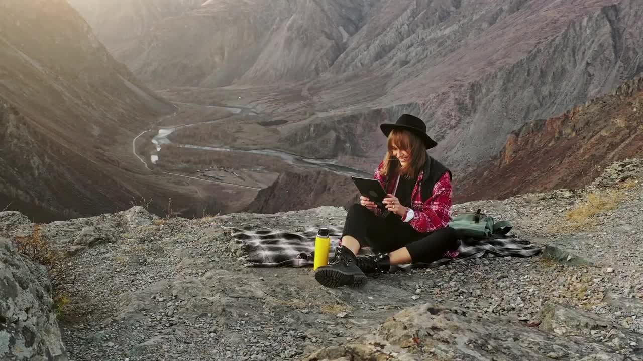 Free Stock Video Woman Using A Tablet On Top Of A Crag Live Wallpaper - Free Download