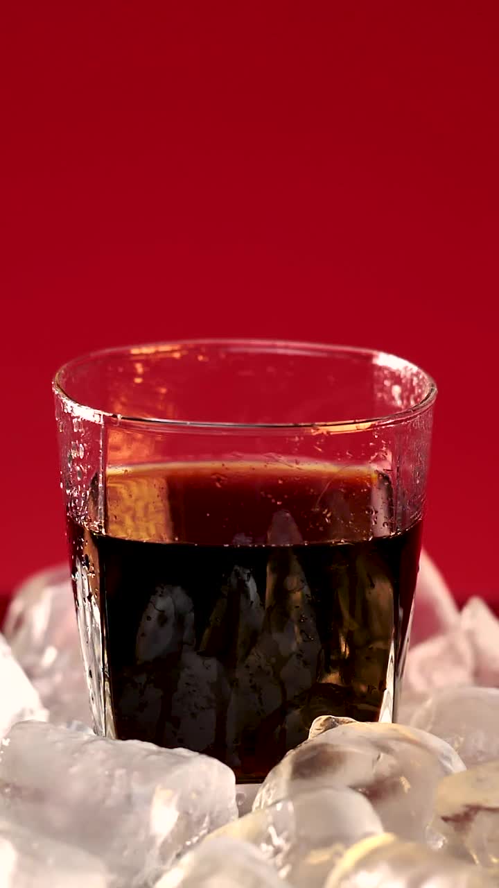 Stock Video Ice Falling Into A Glass With Soda Animated Wallpaper - Free Download