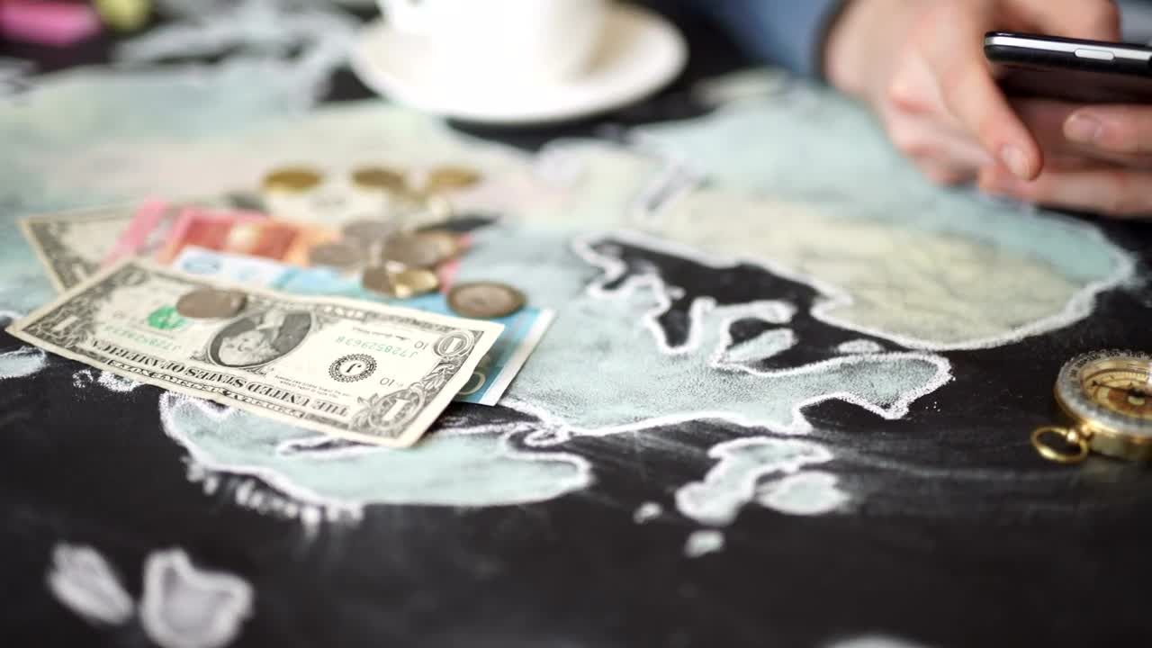 Stock Video Hands Using Mobile On Map With Money And Compass Animated Wallpaper - Free Download