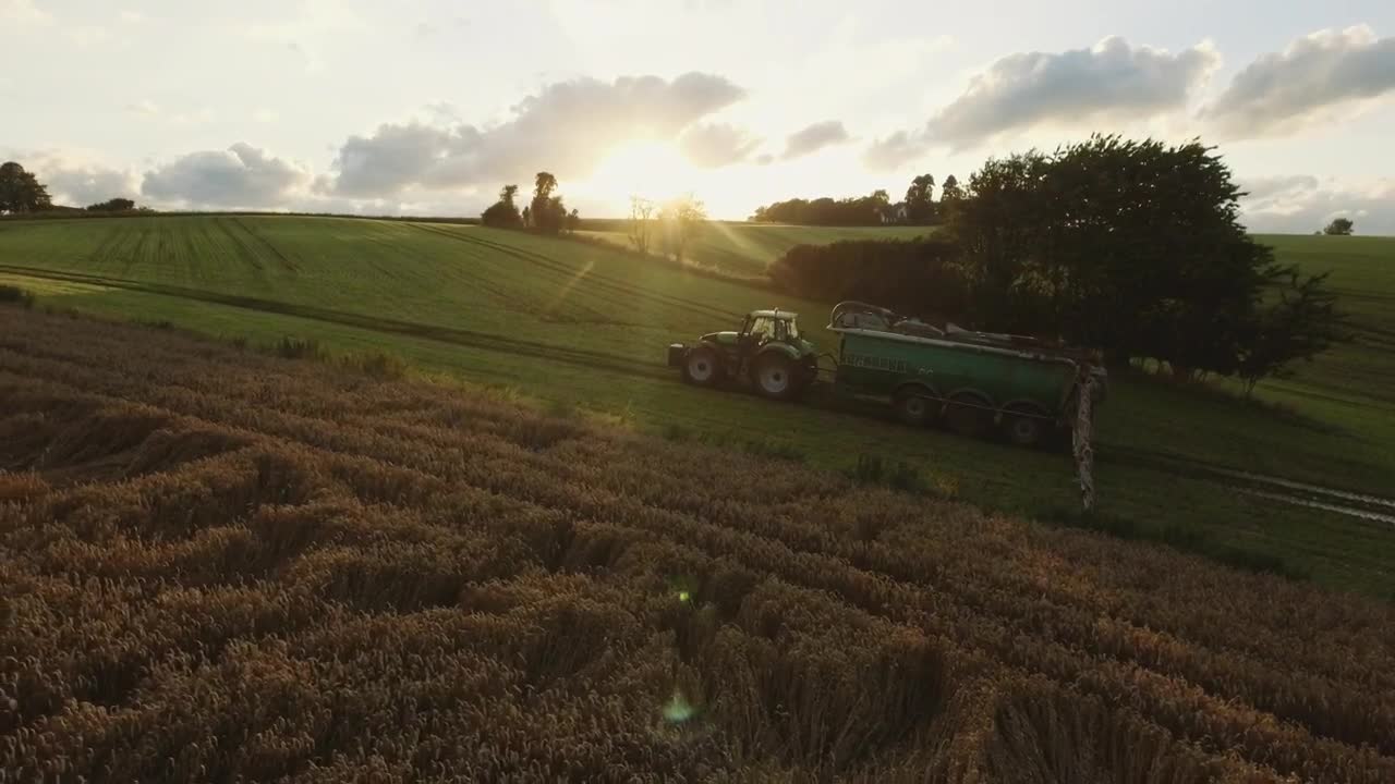 Free Video Stock tractor driving over green fields Live Wallpaper - Free Download