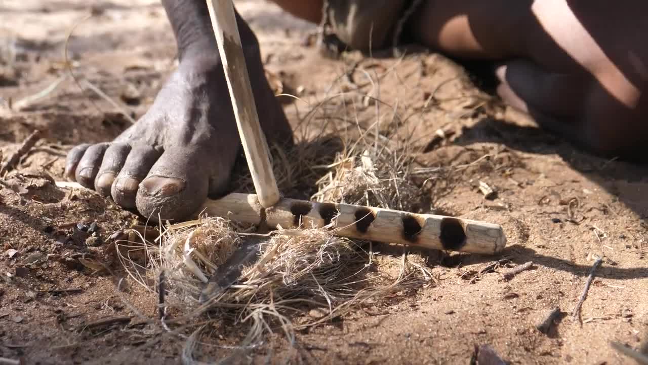 Stock Video Making Fire With Wooden Sticks On The Ground Animated Wallpaper - Free Download