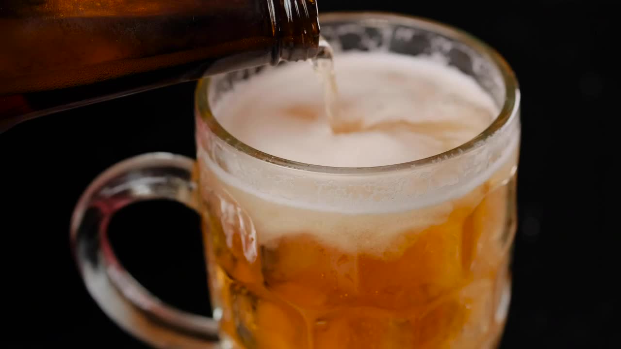 Stock Video Filling A Mug With Beer On A Dark Background Live Wallpaper For PC - Free Download