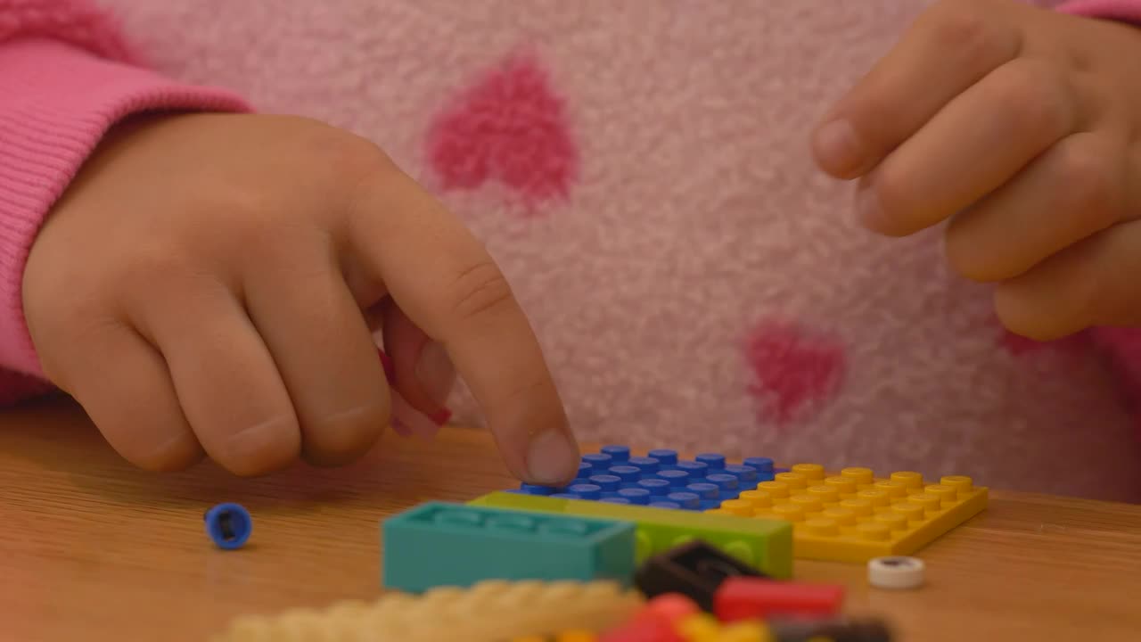 Stock Video Hands Of A Girl Playing With Lego Pieces Animated Wallpaper - Free Download