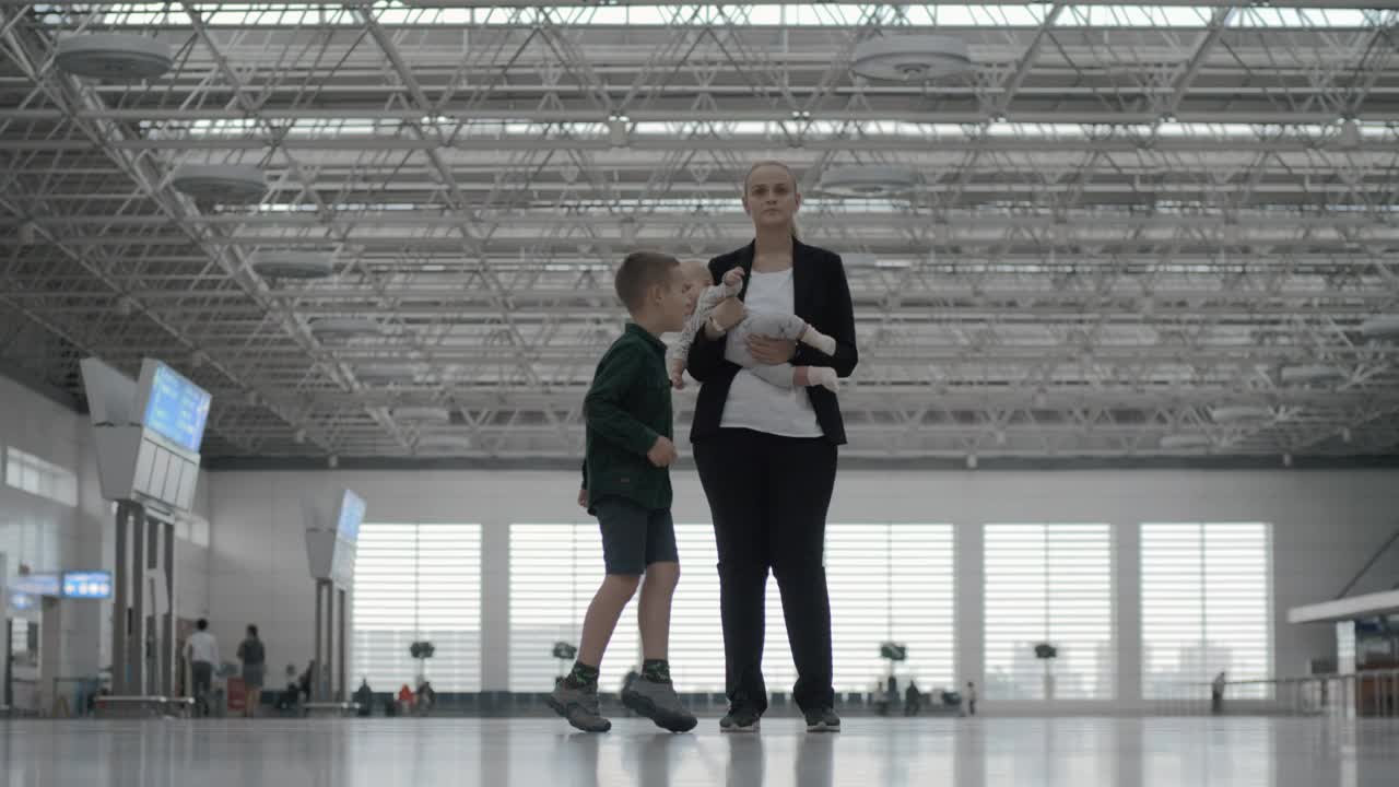 Stock Footage Woman And Her Kids At The Airport Live Wallpaper - Free Download