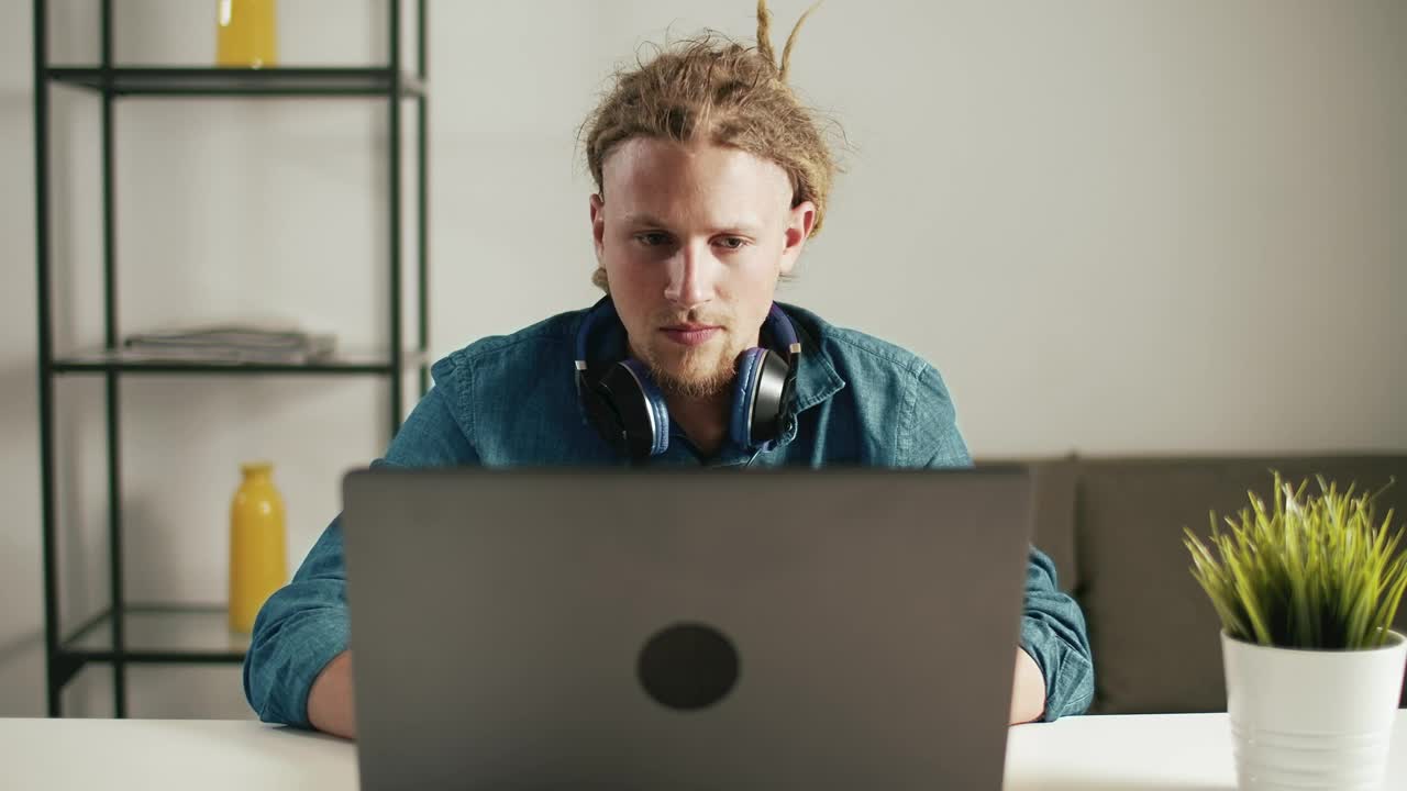 Stock Footage Urban Man Browses Web On Laptop With Headphones Live Wallpaper - Free Download